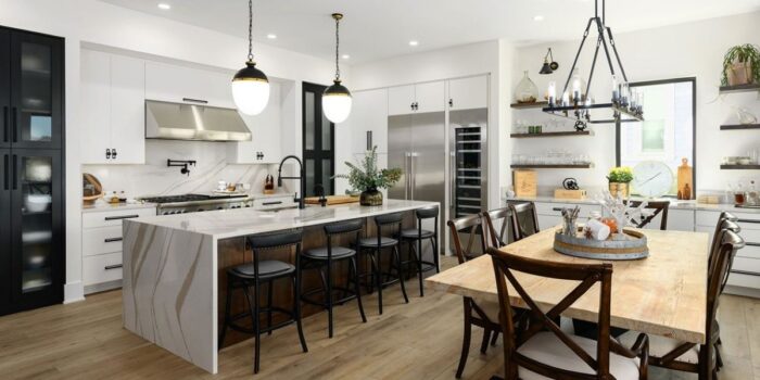 Open concept kitchen with island bar in foreground.